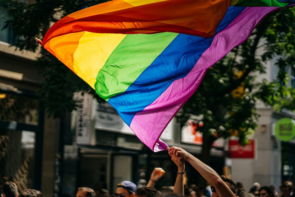 Catholic Relief Services faces legal challenge over LGBTQ benefits dispute A person waves a LGBTQ pride flag.