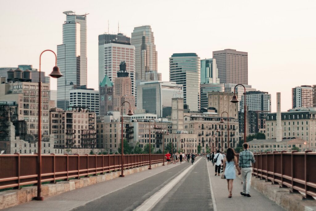 A skyline image with a pedestrian walkway of Minneapolis, MN