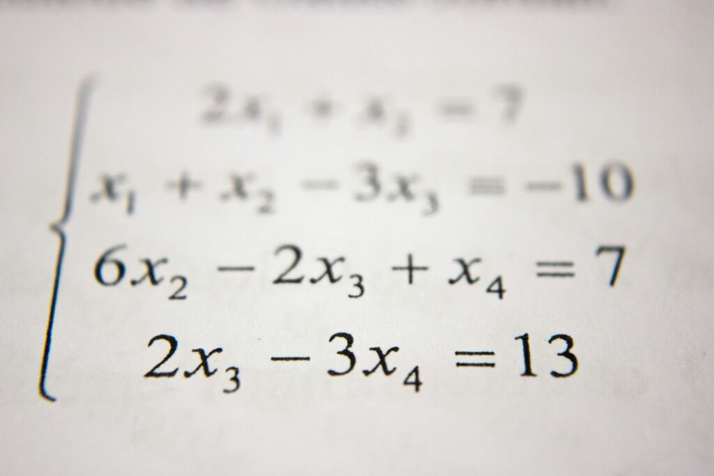 An algebraic equation on a piece of white paper.