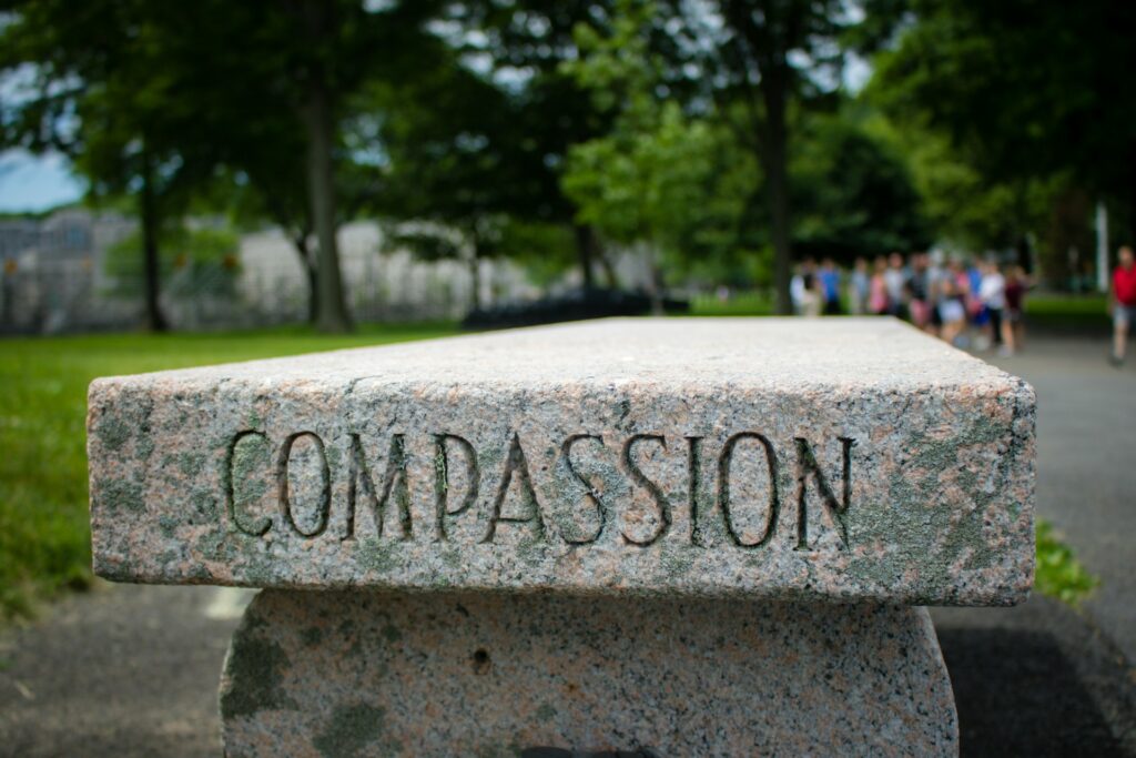 A bench with "Compassion" engraved on it.