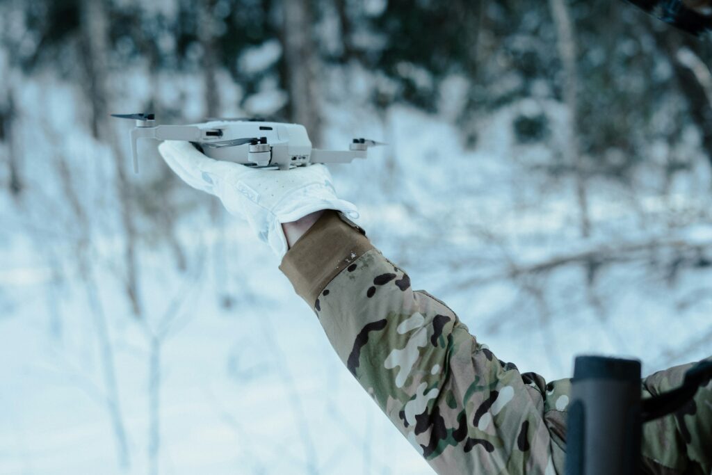 A drone is held in a hand.