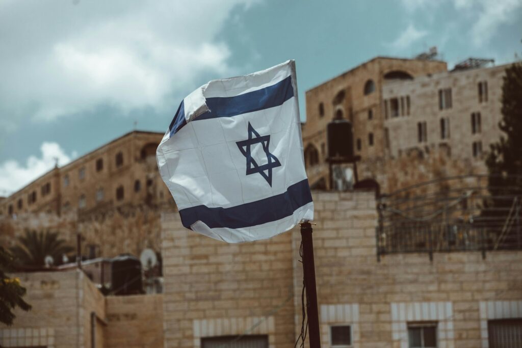 The Israeli flag flying in the wind.