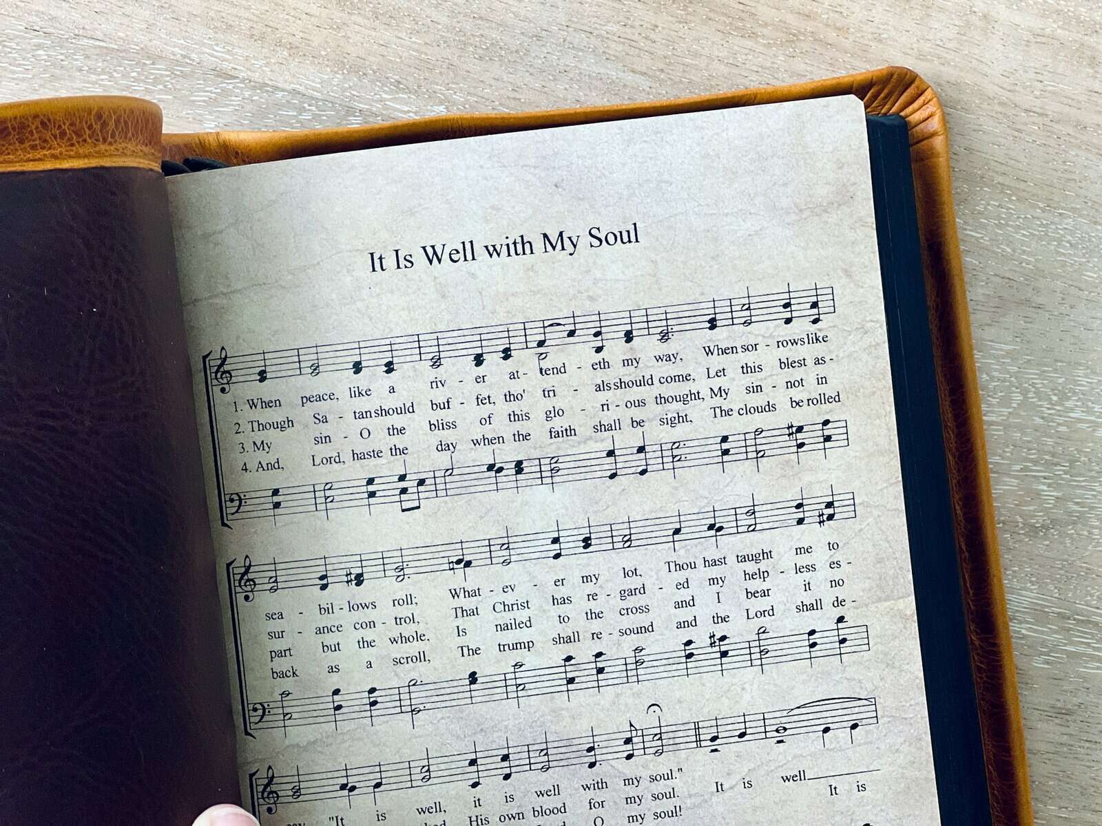 A hymn book is open to It is well with my soul.