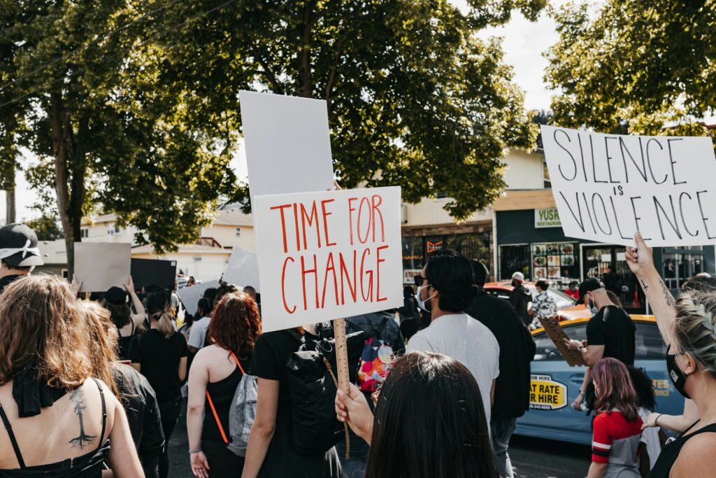 Courage Is Contagious: Clergy fuel new immigration resistance Protestors carrying signs.