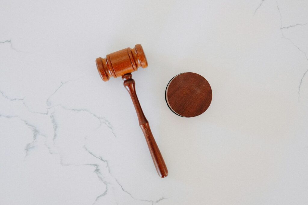 A dark wooden gavel on a marble table top.