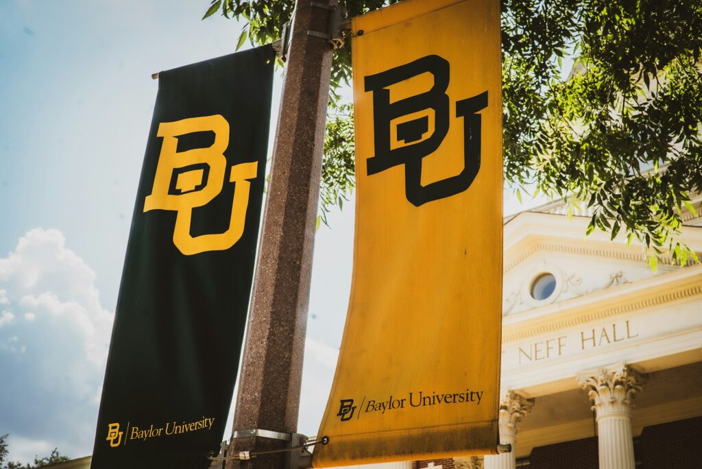Baylor university banners on a pole.