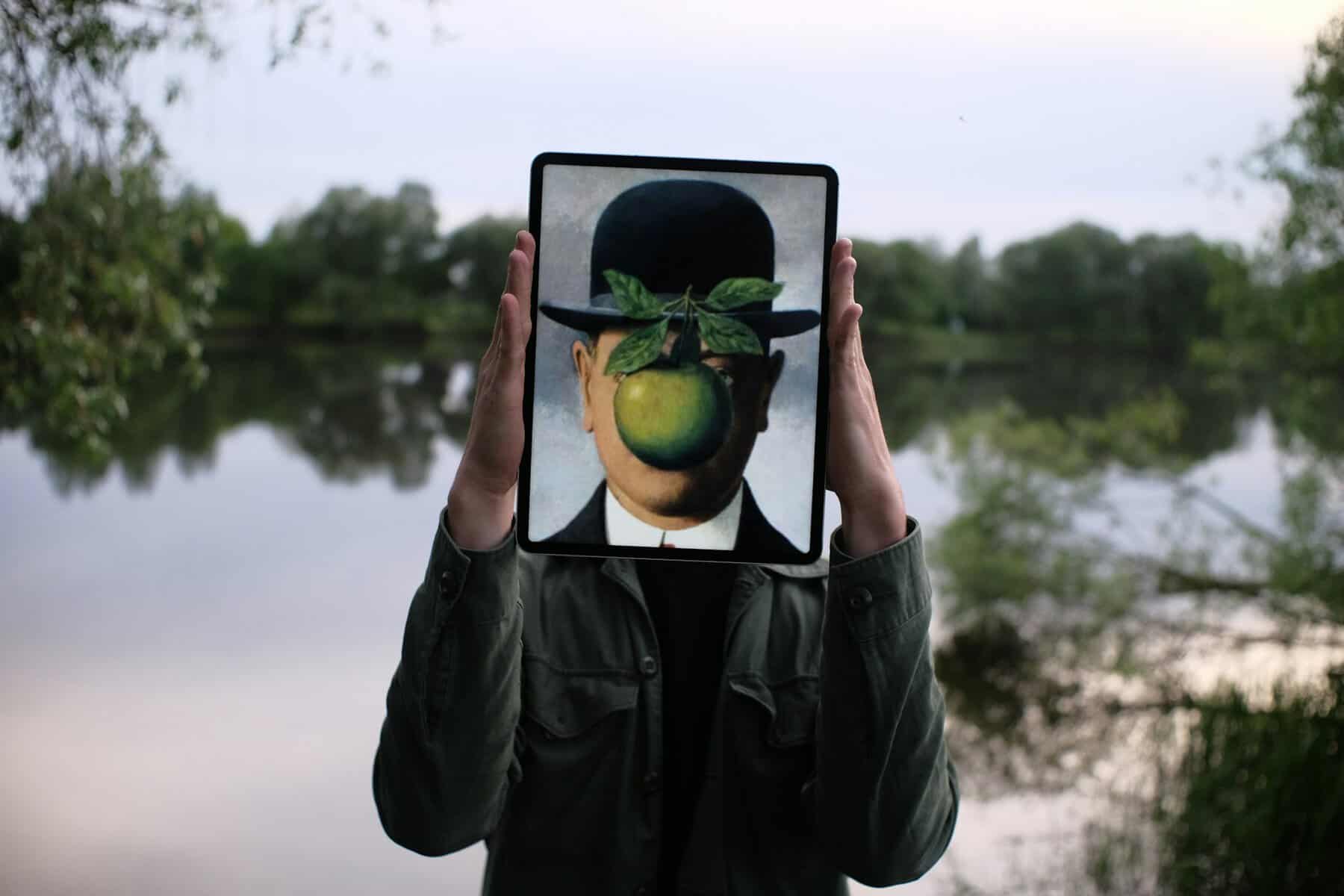 A person holding a depiction of a face in front of their face on a tablet.