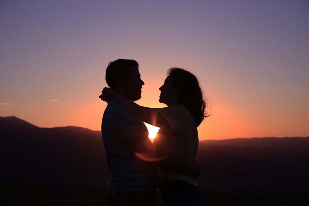 Christian Sexual Ethics for Singles in a Changing Culture A couple in silhouette, embracing at sunset.