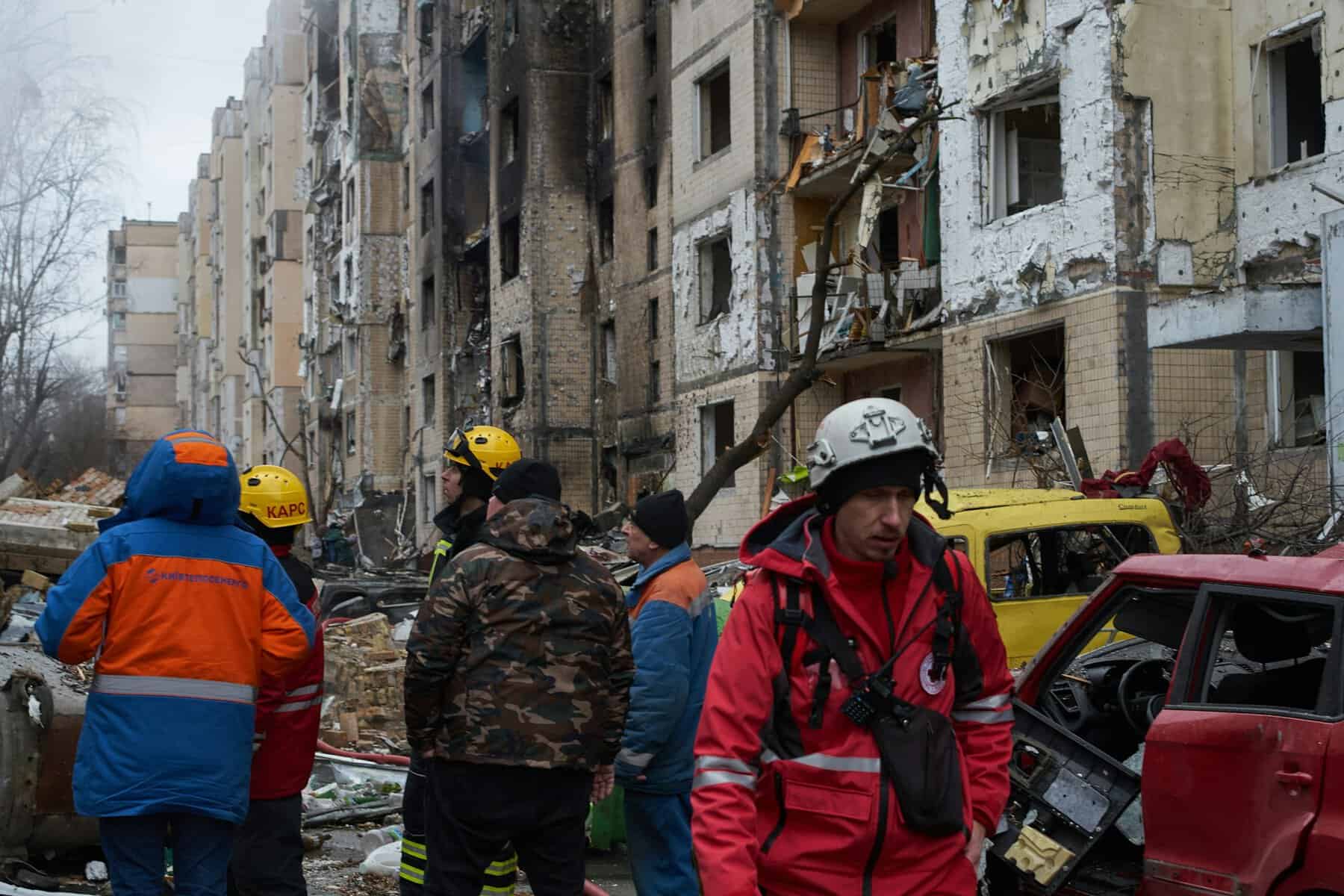 Image of a destroyed residential building and rescue workers ion Kyiv, Ukraine.