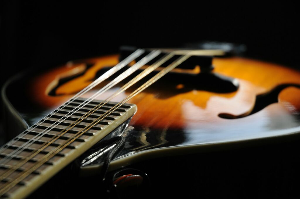 Music That Ministers (Part II): Is it Sanctified if itโs Sourced by Christians? A close-up of the neck and body of a mandolin.