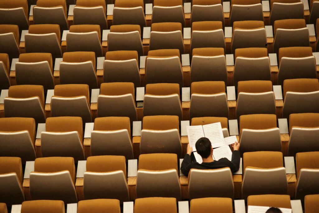 Turning Point USA's Explosive Growth Masks a Deepening Conservative Divide A bird's eye view of person studying in an empty lecture hall.
