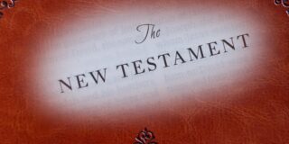 The words The New Testament superimposed upon a Bible cover.