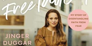 Jinger Duggar Vuolo sits in a brown pantsuit and smiles for this book cover photo.