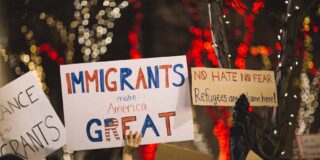 Pro US immigration signs are held in a crowd