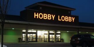 A Hobby Lobby store front is seen lit up at night.