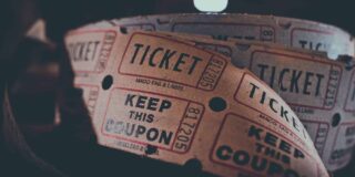 A roll of movie tickets is shown close up.