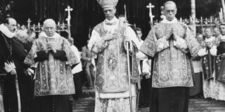 A black and white photo shows a man in priestly vestures.