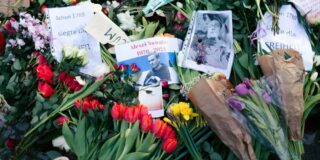 Alexei Navalny's photo sits among flowers in memorium.