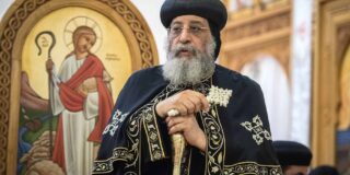 A Coptic Orthodox clergyman with grey beard.